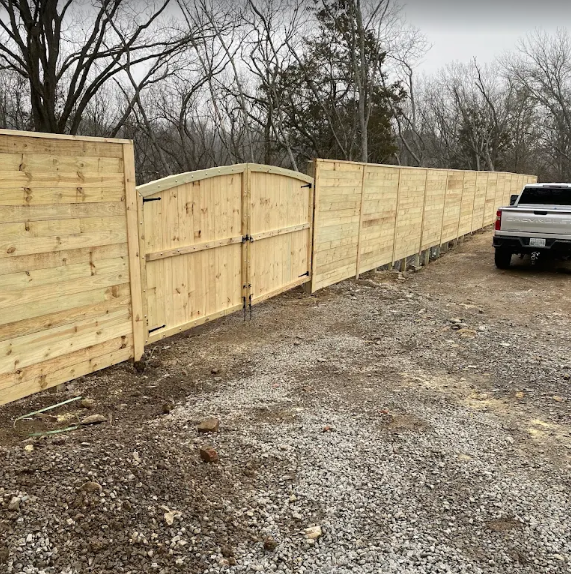 Wood privacy fence with arched double gate