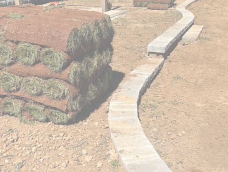 Curved stone curbing edging a new lawn area